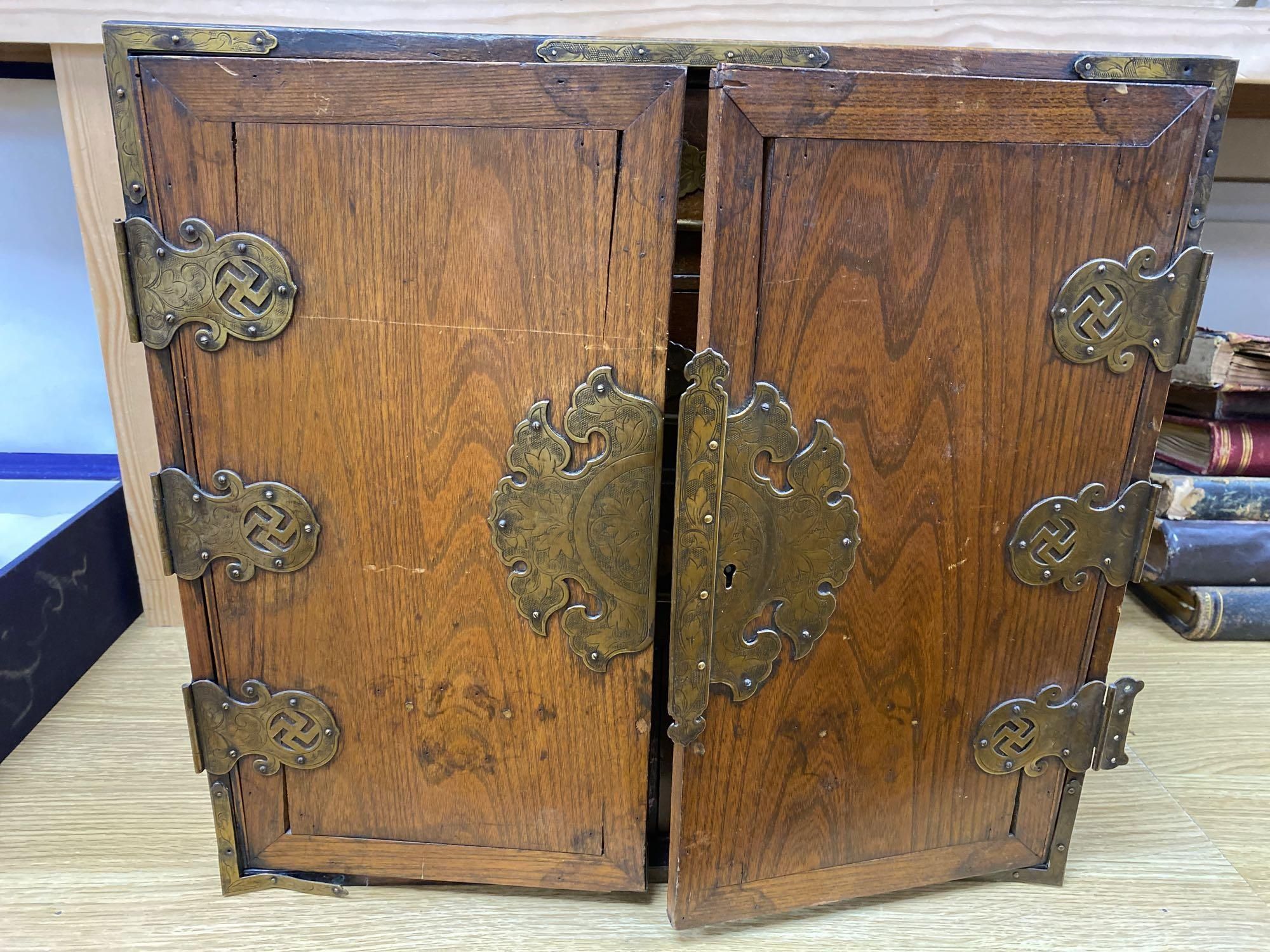 A Korean elm brass mounted table top cabinet
